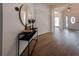 Inviting entryway with a round mirror and a view into the living room and front door at 3020 Templeton Ln, Loganville, GA 30052