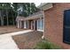 Charming brick home featuring black shutters and a well-manicured lawn at 3020 Templeton Ln, Loganville, GA 30052