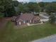 Well-maintained single-story red brick home with a lush lawn and manicured landscaping at 3020 Templeton Ln, Loganville, GA 30052