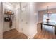 Hallway with wood flooring and an ornate light fixture in an adjacent dining area at 3020 Templeton Ln, Loganville, GA 30052