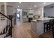 Spacious kitchen with gray cabinets, stainless steel appliances, and a breakfast bar, offering modern convenience at 3020 Templeton Ln, Loganville, GA 30052