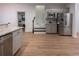 Bright kitchen with stainless steel refrigerator, ample cabinets, and tile backsplash at 3020 Templeton Ln, Loganville, GA 30052
