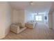 Spacious living room area featuring a comfortable sectional sofa and carpet flooring at 3020 Templeton Ln, Loganville, GA 30052