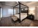 Comfortable main bedroom with a four-poster bed, tray ceilings, and lots of natural light at 3020 Templeton Ln, Loganville, GA 30052