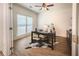 Bright office features a dark desk, hardwood floors and a large window with natural light at 3020 Templeton Ln, Loganville, GA 30052