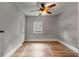 Modest bedroom featuring a wood-look floor, ceiling fan with light, and window at 1090 Harwell Nw St, Atlanta, GA 30314