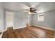 Well-lit bedroom with hardwood floors, ceiling fan, closet, and access to an ensuite bathroom at 1090 Harwell Nw St, Atlanta, GA 30314