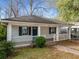 Charming single-story home featuring a covered porch, blue shutters, and well-maintained landscaping at 1090 Harwell Nw St, Atlanta, GA 30314