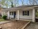 Inviting single-story home with a covered porch, blue shutters, and a cozy, classic appeal at 1090 Harwell Nw St, Atlanta, GA 30314