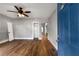 Open living room with new hardwood floors, neutral walls, ceiling fan, and ample natural light at 1090 Harwell Nw St, Atlanta, GA 30314