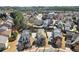 An aerial view of a neighborhood with many homes, mature trees, and winding streets at 1917 Baxley Pine Trce, Suwanee, GA 30024