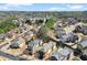 An aerial view of a neighborhood with many homes, mature trees, and winding streets at 1917 Baxley Pine Trce, Suwanee, GA 30024