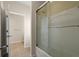 Bathroom with glass shower enclosure, tiled walls and floors, and neutral coloring at 1917 Baxley Pine Trce, Suwanee, GA 30024