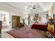 Expansive bedroom featuring neutral walls, tray ceiling, and a variety of decor and natural light at 1917 Baxley Pine Trce, Suwanee, GA 30024