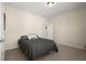Standard bedroom with plush carpeting, gray comforter, light walls and basic decor at 1917 Baxley Pine Trce, Suwanee, GA 30024