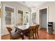 Well-lit dining area with a table, chairs, and view to the exterior and back entrance at 1917 Baxley Pine Trce, Suwanee, GA 30024