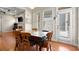 A dining room with wood floors, marble topped table, six chairs, lots of natural light and adjacent to a living room at 1917 Baxley Pine Trce, Suwanee, GA 30024