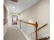 Upstairs hallway with white railings, hardwood stairs, and neutral decor at 1917 Baxley Pine Trce, Suwanee, GA 30024