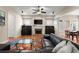 Cozy living room with a fireplace, built-ins, a large sofa, and plenty of natural light at 1917 Baxley Pine Trce, Suwanee, GA 30024