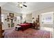 Bright bedroom with detailed red carpet, and an entrance to the main bathroom at 1917 Baxley Pine Trce, Suwanee, GA 30024