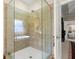 Modern walk-in shower with glass door and tiled surround at 1917 Baxley Pine Trce, Suwanee, GA 30024