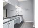 Spacious bathroom featuring a double sink vanity with granite countertop and grey tile flooring at 1979 Resting Creek Dr, Decatur, GA 30035