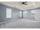 Expansive bedroom featuring neutral walls, carpet flooring, and multiple windows at 1979 Resting Creek Dr, Decatur, GA 30035