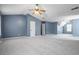 Spacious carpeted bedroom featuring a ceiling fan and natural light at 1979 Resting Creek Dr, Decatur, GA 30035