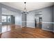 Open-concept dining room with hardwood floors, gray walls, chandelier and seamless connection to other spaces at 1979 Resting Creek Dr, Decatur, GA 30035