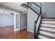 Welcoming entryway featuring hardwood floors, staircase with dark wood railing and gray walls at 1979 Resting Creek Dr, Decatur, GA 30035