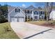 Charming two-story home with a well-manicured lawn, two car garage, and inviting entrance at 1979 Resting Creek Dr, Decatur, GA 30035