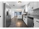 Open-concept kitchen featuring white cabinets, stainless steel appliances and granite counters at 1979 Resting Creek Dr, Decatur, GA 30035
