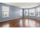 Cozy living room featuring hardwood floors, three windows and gray walls at 1979 Resting Creek Dr, Decatur, GA 30035