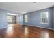 Bright living room with hardwood floors, two windows and gray walls at 1979 Resting Creek Dr, Decatur, GA 30035