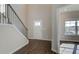 Bright entryway with hardwood floors and staircase leading to upper level at 212 Eleanora Way, Loganville, GA 30052
