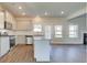 Modern kitchen features stainless steel appliances, granite countertops, and an island at 212 Eleanora Way, Loganville, GA 30052