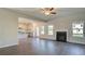 Open-concept living room with fireplace seamlessly connects to modern kitchen at 212 Eleanora Way, Loganville, GA 30052