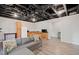 Basement area with a kitchenette, exposed ceiling, and comfortable sofa for versatile living space at 273 Amylou Cir, Woodstock, GA 30188