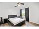 Bedroom with hardwood floors, a ceiling fan, a large window, and a sleek bed at 273 Amylou Cir, Woodstock, GA 30188