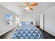 Well-lit room with a ceiling fan, multiple windows, and dark floors at 273 Amylou Cir, Woodstock, GA 30188