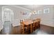 Spacious dining room featuring a large wooden table, wainscoting, and hardwood floors at 273 Amylou Cir, Woodstock, GA 30188