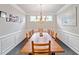 Formal dining room with a large wooden table, stylish chandelier, and elegant wainscoting at 273 Amylou Cir, Woodstock, GA 30188