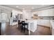 Spacious kitchen boasts white cabinets, stainless steel appliances, and a center island with seating at 273 Amylou Cir, Woodstock, GA 30188