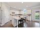 Modern kitchen with white cabinets, stainless steel appliances, and a spacious center island with seating at 273 Amylou Cir, Woodstock, GA 30188