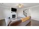 Living room with a fireplace, hardwood floors, staircase, and a comfortable sofa at 273 Amylou Cir, Woodstock, GA 30188