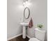 Compact powder room featuring a pedestal sink, oval mirror, and modern fixtures at 273 Amylou Cir, Woodstock, GA 30188