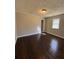 Bedroom with hardwood floors, neutral paint, and a window with a view of the outdoors at 1027 N Born Rd, Stone Mountain, GA 30088