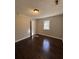 Comfortable bedroom featuring fresh paint, hardwood flooring, and natural light from a window at 1027 N Born Rd, Stone Mountain, GA 30088