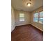 Cozy bedroom with hardwood floors, two windows, and neutral paint, offering a bright and airy retreat at 1027 N Born Rd, Stone Mountain, GA 30088