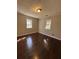 Bright bedroom with hardwood floors and two windows bringing in natural light at 1027 N Born Rd, Stone Mountain, GA 30088